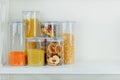 Assortment of grain products and pasta in glass storage containers on white wooden table. Healthy cooking, clean eating, zero