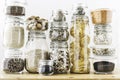 Assortment of grain products and pasta in glass storage containers on wooden table. Healthy cooking, clean eating, zero