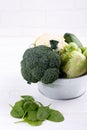 Assortment green vegetables on white table.  Broccoli, cauliflower, brussels sprouts, kohlrabi, avocado, asparagus, spinach. Royalty Free Stock Photo