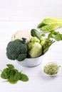 Assortment green vegetables on white table.  Broccoli, cauliflower, brussels sprouts, kohlrabi, avocado, asparagus, spinach, Royalty Free Stock Photo