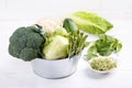 Assortment green vegetables on white table.  Broccoli, cauliflower, brussels sprouts, kohlrabi, avocado, asparagus, spinach, Royalty Free Stock Photo