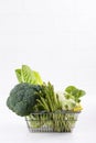 Assortment green vegetables on white table.  Broccoli, cauliflower, brussels sprouts, kohlrabi, avocado, asparagus, spinach, Royalty Free Stock Photo