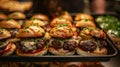 Assortment of grilled mini burgers with toppings on a tray Royalty Free Stock Photo