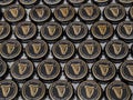 Assortment of Guinness Used Beer Bottles Caps on Display