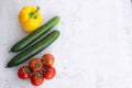 Assortment of healthy food, fresh green red yellow organic vegetables. cucumber, bell pepper, tomatoes on gray concrete Royalty Free Stock Photo