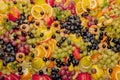 Assortment of healthy raw fruits, platter background, apple, pear, grapes, orange, mandarin, top view, selective focus Royalty Free Stock Photo