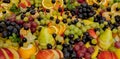 Assortment of healthy raw fruits, platter background, apple, pear, grapes, orange, mandarin, top view, selective focus Royalty Free Stock Photo