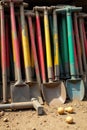 Assortment of heavy duty mining tools scattered on dusty ground, suggesting recent activity A collection of weathered, heavy duty Royalty Free Stock Photo