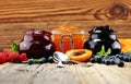 Assortment of jams, seasonal berries, apricot, mint and fruits. Royalty Free Stock Photo