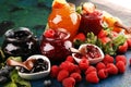 Assortment of jams, seasonal berries jelly, mint and fruits and tangerine