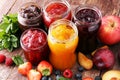 Assortment of jams, seasonal berries, plums, mint and fruits.