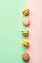 Assortment of macarons strawberry pistachio coffee passion fruit caramel flavor on duotone pastel green chartreuse pink background