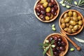 Assortment from marinated olives in wooden bowls top view.