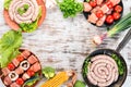 Assortment of meat for barbecue. Sausages, skewers and vegetables. On a wooden background. Royalty Free Stock Photo