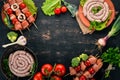 Assortment of meat for barbecue. Sausages, skewers and vegetables. On a wooden background. Royalty Free Stock Photo