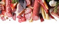 Assortment of meat products including sausage ham bacon spices garlic on a white background isolated view from the top