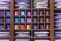 Assortment of men`s shirts and ties on the wooden shelves of a showcase in a shop. Front view. Close-up