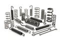 Assortment of Metal Springs and Coiled Metal Components on White Background Royalty Free Stock Photo