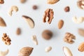 Assorted nuts flying above white background, levitation effect