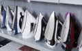 Assortment of modern irons at household appliances store