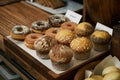 Assortment muffin and donuts on wooden table. Breakfast buffet c