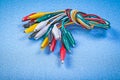 Assortment of multicolored crocodile clip cables on blue backgro Royalty Free Stock Photo