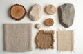 Assortment of natural materials arranged on white surface. Collection includes wood, stone, and fabric samples. Display of Royalty Free Stock Photo