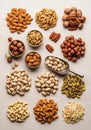 An assortment of nuts arranged methodically on a light wooden surface. Includes Royalty Free Stock Photo