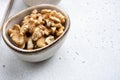 Assortment of nuts in bowl, on white stone table background, with copy space for text Royalty Free Stock Photo