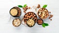 Assortment of nuts in bowls on white wooden background. free space for your text. Royalty Free Stock Photo