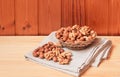 Assortment of nuts in wicker basket on wooden table. Selective focus Royalty Free Stock Photo