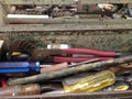 Assortment of old, used screwdrivers and other tools in a metal Royalty Free Stock Photo