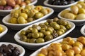 Assortment of olives on the plate in bulk. Royalty Free Stock Photo