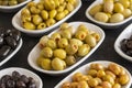 Assortment of olives on the plate in bulk. Selective focus Royalty Free Stock Photo