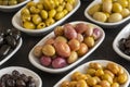 Assortment of olives on the plate in bulk. Selective focus Royalty Free Stock Photo