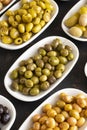 Assortment of olives on the plate in bulk. Selective focus Royalty Free Stock Photo