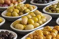 Assortment of olives on the plate in bulk. Selective focus Royalty Free Stock Photo