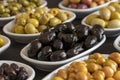 Assortment of olives on the plate in bulk. Selective focus Royalty Free Stock Photo