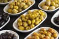 Assortment of olives on the plate in bulk. Selective focus Royalty Free Stock Photo