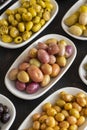 Assortment of olives on the plate in bulk. Selective focus Royalty Free Stock Photo