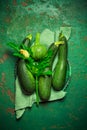 Assortment of organic courgettes and zucchinis on green background Royalty Free Stock Photo