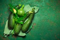 Assortment of organic courgettes and zucchinis on green background Royalty Free Stock Photo