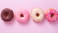 Assortment of pastel colorful donuts on pink table top view, flat lay. Banner for confectionary Royalty Free Stock Photo