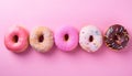 Assortment of pastel colorful donuts on pink table top view, flat lay. Banner for confectionary Royalty Free Stock Photo