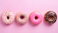 Assortment of pastel colorful donuts on pink table top view, flat lay. Banner for confectionary Royalty Free Stock Photo