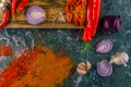 Assortment of peppers, garlic and onions on a stone countertop Royalty Free Stock Photo