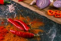 Assortment of peppers, garlic and onions on a stone countertop Royalty Free Stock Photo