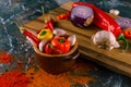 Assortment of peppers, garlic and onions on a stone countertop Royalty Free Stock Photo