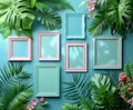 A collection of empty pink and blue picture frames arranged in a creative flat lay among vibrant tropical leaves. Royalty Free Stock Photo