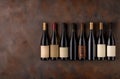 Assortment of premium red wine bottles on rustic background Royalty Free Stock Photo